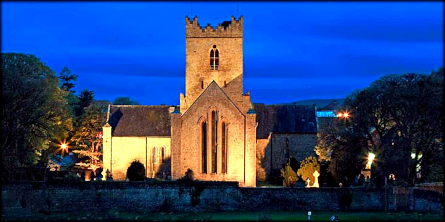 St Flannan's Cathedral floodlit at dusk